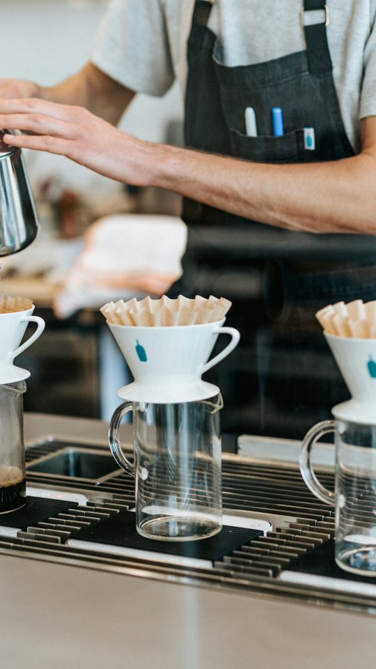 man pouring on cup