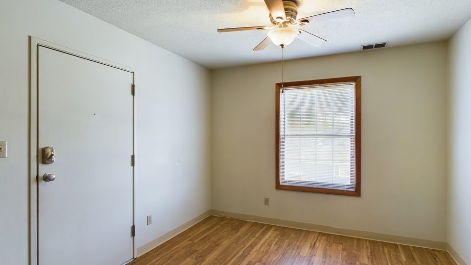 empty room with hardwood floors and ceiling fan at The Chesterfield Apartments