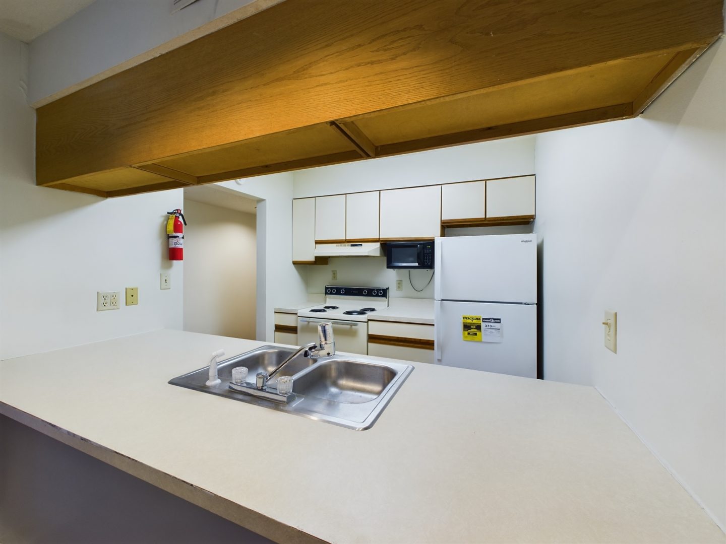 a kitchen with a sink and a stove top at The Chesterfield Apartments